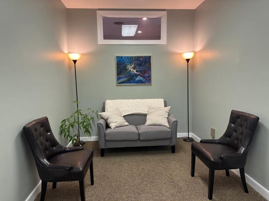 Calm therapy room with sofa and artwork