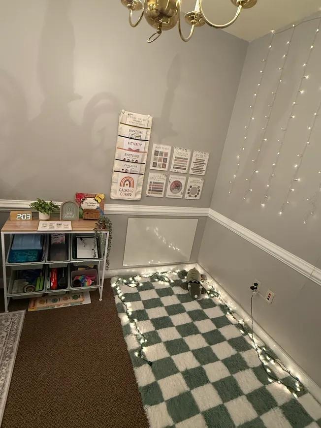 Calming corner with string lights and activity shelves